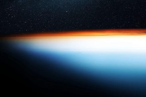 Sunset on the beautiful blue planet earth, view from space. Beautiful blue planet sinking into darkness in space