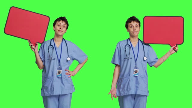 Medical assistant holding a red speech bubble icon against greenscreen