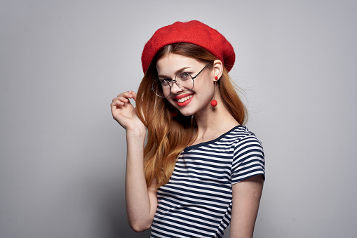pretty woman wearing glasses posing fashion attractive look red earrings jewelry. High quality photo