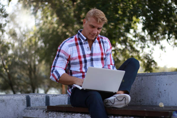 istock Modern mature businessman work online 2119710509