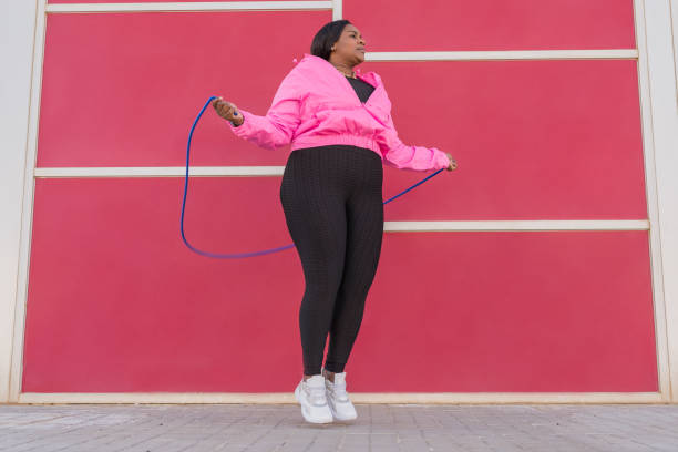 Curvy African American woman skipping rope