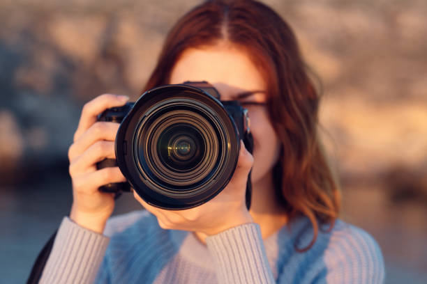 istock woman with professional camera outdoors in mountains front view 2119718870