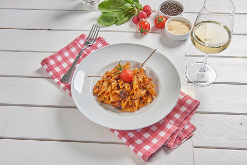 Pasta and macaroni in the plate for menu style with sauce background.