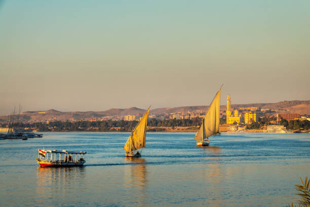 istock Feluccas (traditinal egyptian sailing boats) on the Nile river at sunset  in Aswan, Egypt 2119724428
