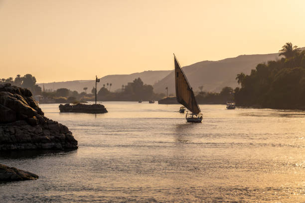 istock Felucca (traditinal egyptian sailing boat) on the Nile river at sunset  in Aswan, Egypt 2119726628