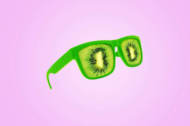 istock Creative green kiwi glasses hovering over a pastel pink background. Creative idea for vitamins and health. Juicy exotic summer, concept. Vitamins raw. Color combination 2119752755