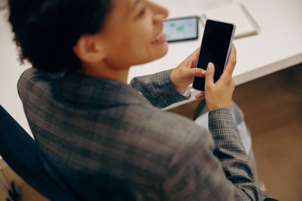 istock Close up of female freelancer working on digital tablet and use phone while sitting in coworking 2119793472