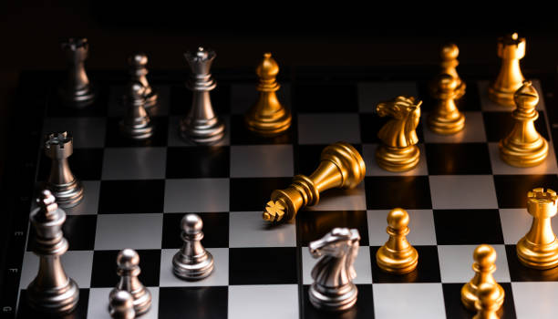 istock Fallen gold king in a strategic chess match. Checkmate. 2119796155