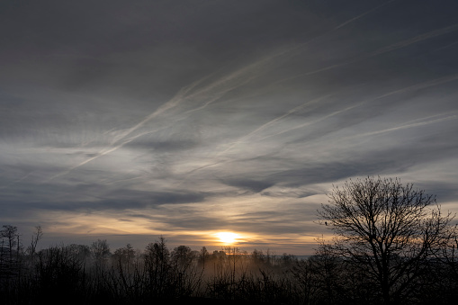 View of a colorful sunrise with mist in the Normandy countryside