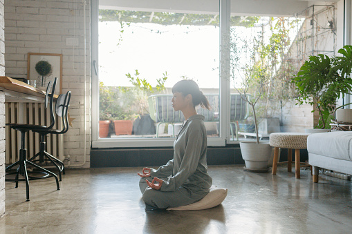 Photo of a Japanese woman starting off the day right: with morning meditation and mindfulness