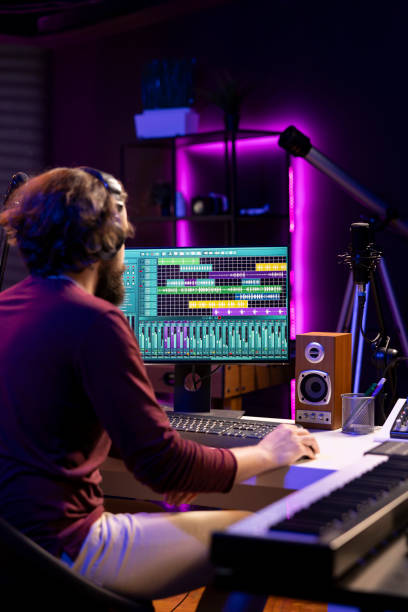 istock Audio engineer operates mixing equipment and oversees recordings 2119830650