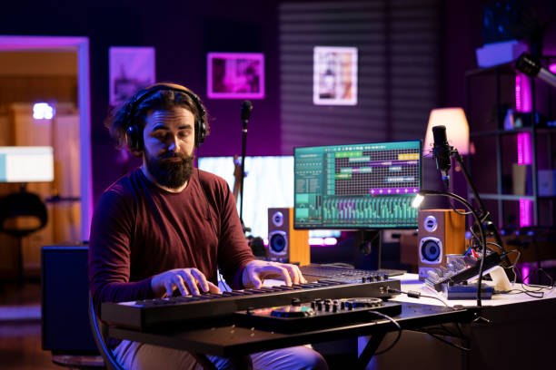 istock Artist playing piano midi controller and recording new tunes 2119834348