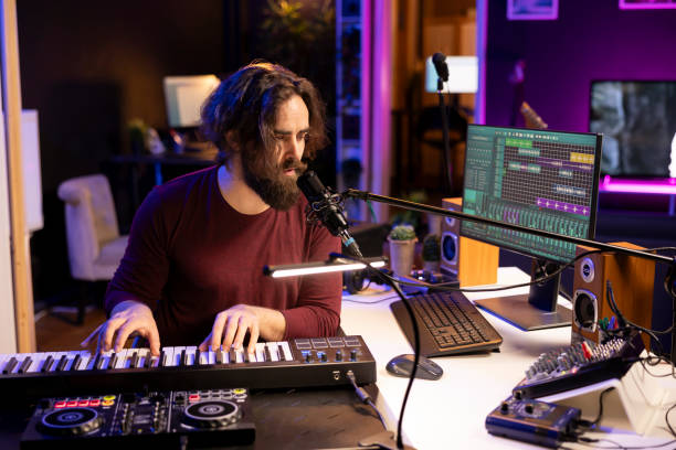 istock Creative musician recording new tunes with microphone and midi controller 2119835378