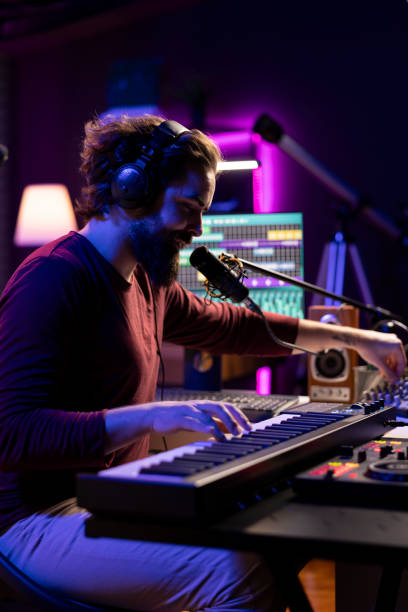 istock Audio engineer playing piano electronic keyboard to compose a new song 2119839075