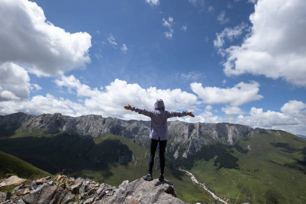 istock Successful woman hiking on alpine mountain peak 2119844891