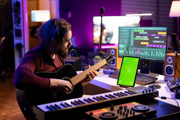 istock Sound engineer artist playing acoustic guitar in his home studio 2119845961