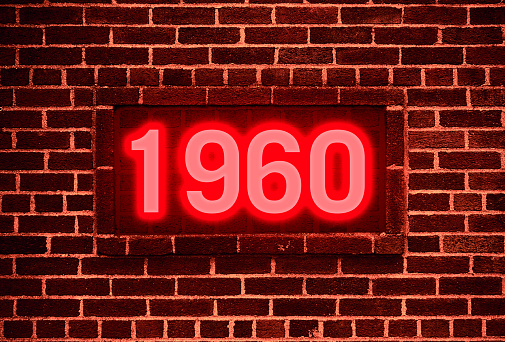 1960 Neon sign on a brick wall