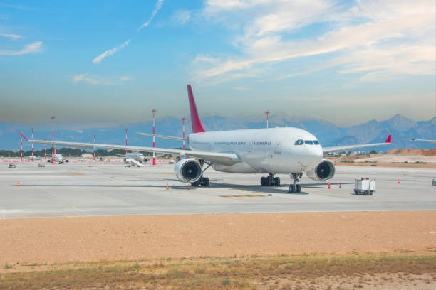 istock Front view at airplane jet standing on parking, mobile ladders nearby, preparation for the upcoming flight. 2119870565