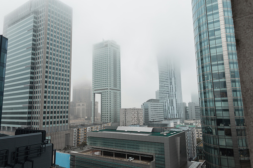 Amazing beautiful modern European city of Warsaw, Poland with its tall business buildings and the Palace of Culture on a foggy cloudy day. Business and finance architecture