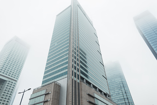 Foggy city with beautiful modern business and office buildings in Warsaw. Economics, finance and construction