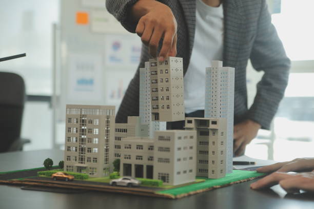 istock Team of architectures and businessmen discussing and brainstorming on floor plan modification for real estate investment and housing development project 2119879270