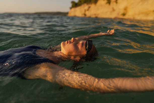 istock Athlete's relaxing after numerous laps done in the sea 2119879318