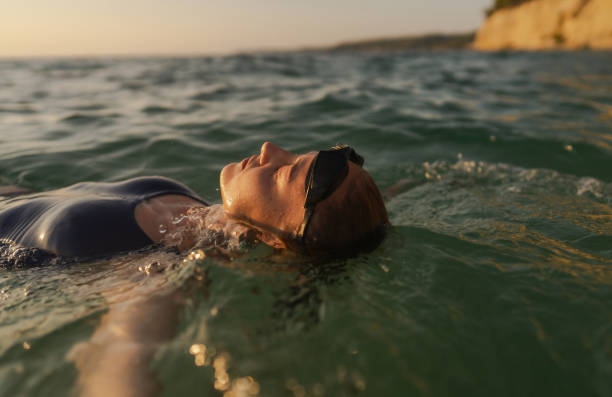istock Athlete's relaxing after numerous laps done in the sea 2119879728