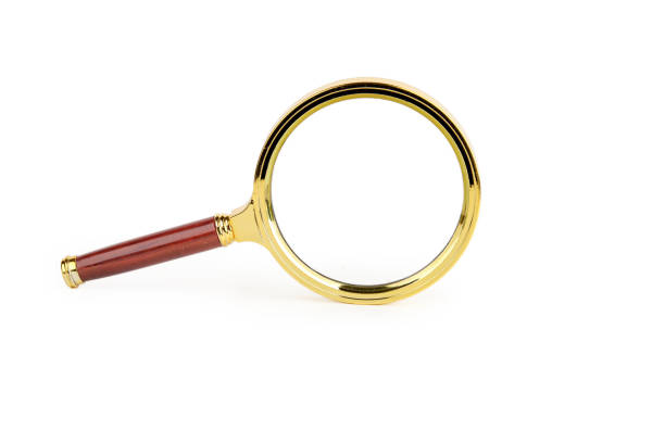 A magnifying glass with a beautiful handle stands on the end on a white background