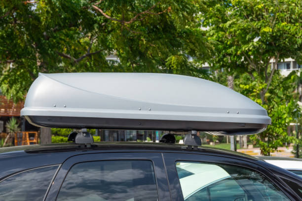 istock Black plastic car rooftop cargo box or roof carrier for traveling. Removable storage container mounted on car roof rack 2119906876