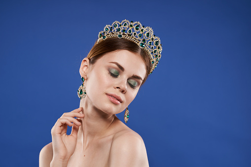 Princess luxury naked shoulders cosmetics fashion fun blue background. High quality photo