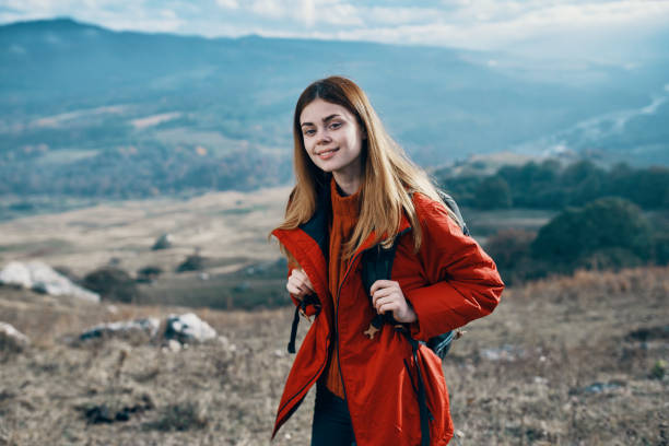 istock woman outdoors in mountains landscape rocks model 2119935990