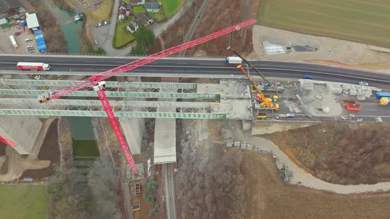 Above View Of Cranes Working On Road Bridge Construction Site. Aerial Drone Shot