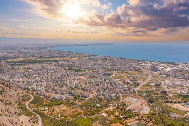 istock Flight over ridge mountain, bird's eye view sunrise sunset dawn evening morning overlooking the city, houses and buildings, roads and ships, Mediterranean coast, resort area, vacation trip. 2119942554