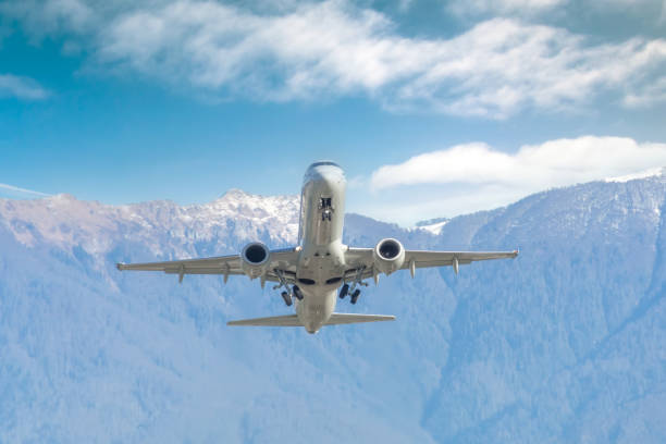 istock Passenger jet airliner takes off rapidly over a mountain range against the background with a clouds blue sky 2119944142