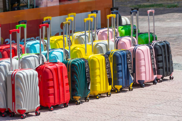 istock Colorful new different suitcases displayed in a row for sale in a store selection assortment. 2119951075