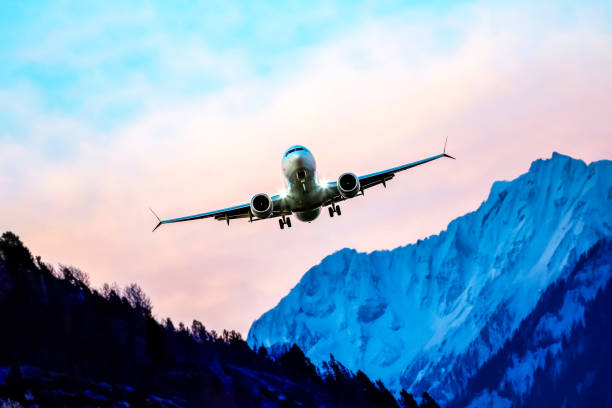 istock passenger plane flies over the mountains. air transport industry 2119954969