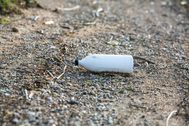 istock Plastic bottle on the shore of the lake 2119984121