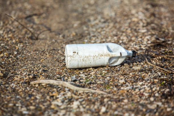 istock Plastic bottle on the shore of the lake 2119984122