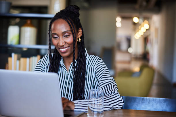 istock Smiling young businesswomen working on a laptop at an office table 2119987370