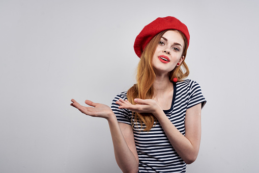 beautiful woman wearing a red hat makeup France Europe fashion posing isolated background. High quality photo