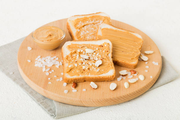 Peanut butter sandwiches or toasts on light table background.Breakfast. Vegetarian food. American cuisine top view vith copy space