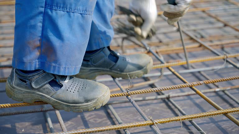 Construction worker in work boots navigating various materials on site