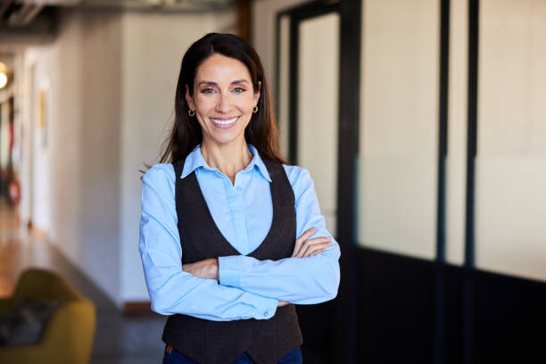 istock Confident mature businesswoman smiling while standing in an office 2120014497