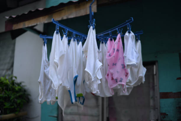 Women's socks hang from a dryer rack near a window in a Canadian home.