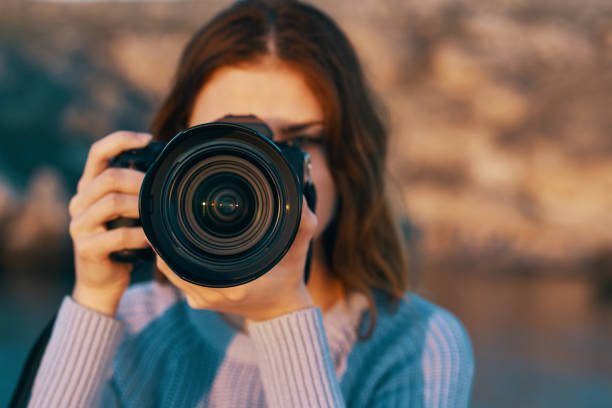 istock woman with professional camera outdoors in mountains front view 2120037192