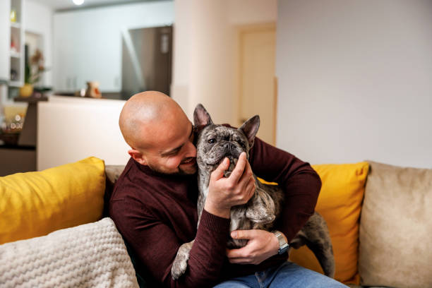 istock Man embraces loving dog 2120042793