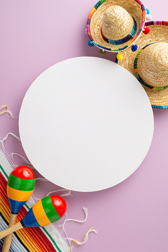 Capture the essence of Cinco de Mayo with overhead vertical imagery of distinctive accessories, including wide-brimmed hats, maracas, a colorful serape against a pale purple backdrop with empty circle