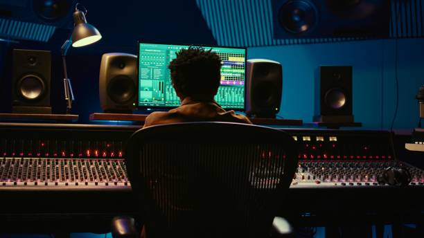 istock African american sound designer mixing and mastering tracks in studio 2120051398