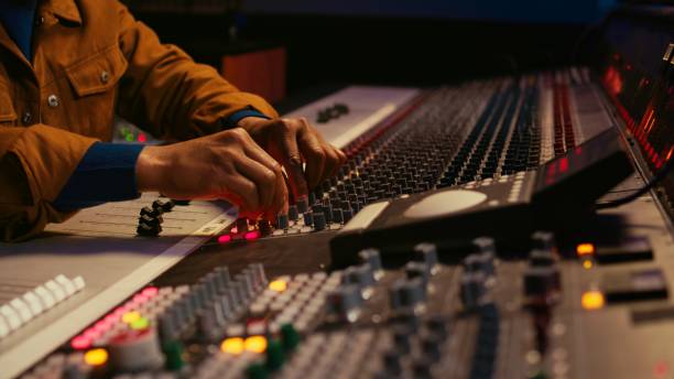 istock African american producer uses control desk with automatic equalizer 2120053058