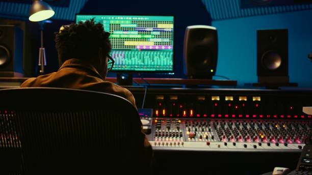 istock African american audio engineer using sound mixing console for managing tracks 2120054666